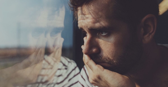 sad man looking outside