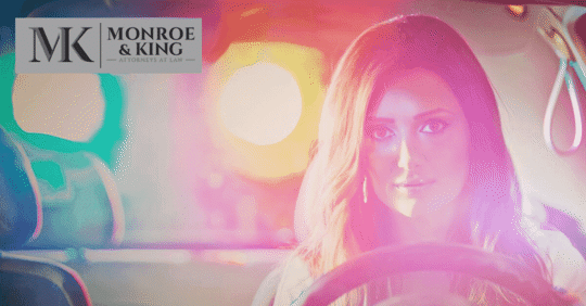 Girl in car with police lights behind - underage DUI