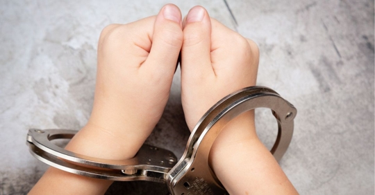 Young hands in handcuffs