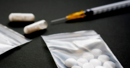 pills, syringe, bag of powdered cocaine