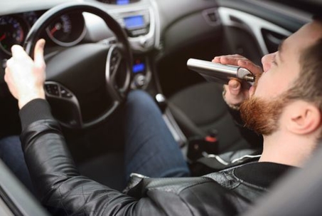 Man Drinking in Car